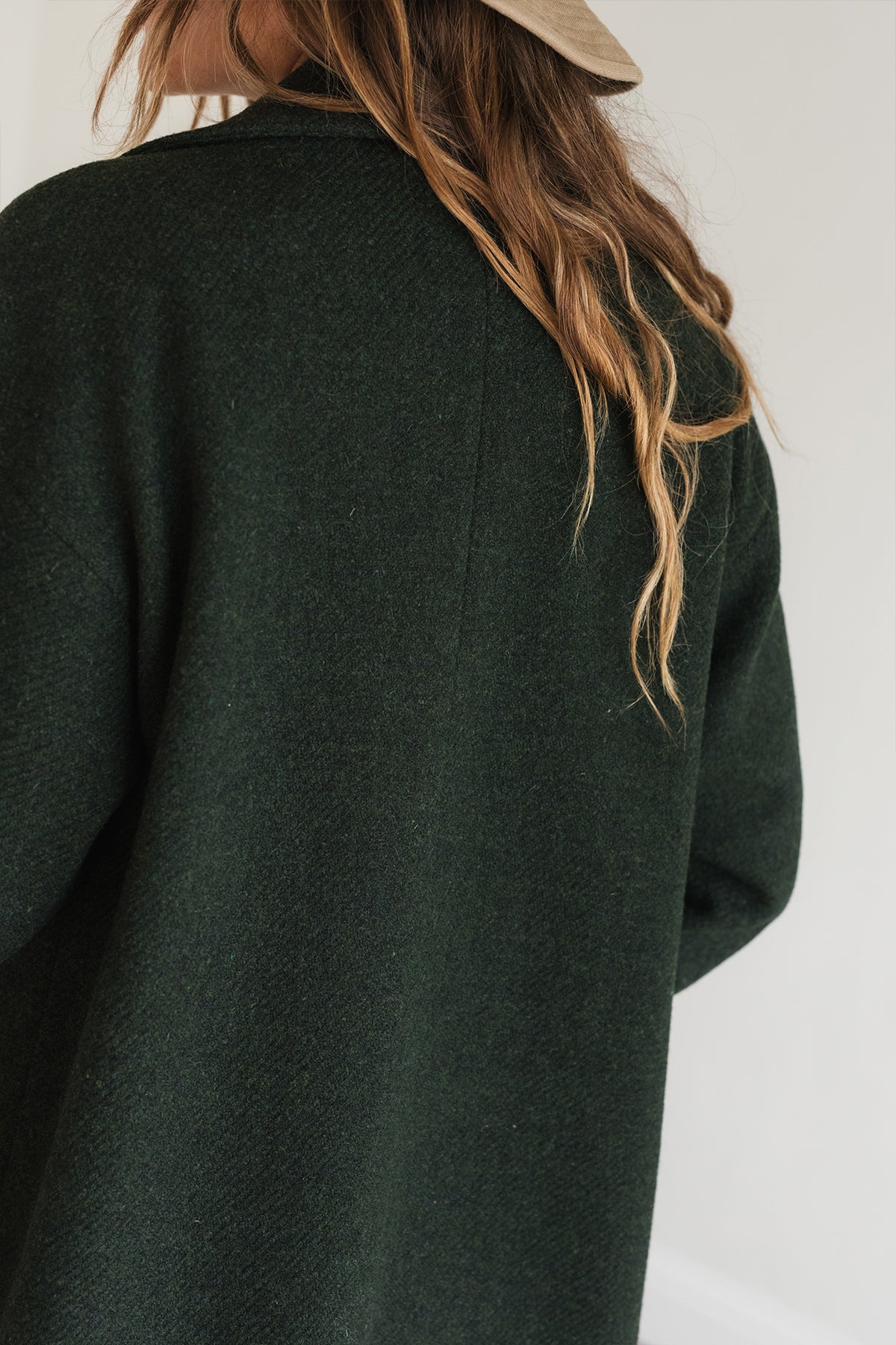 Back of dark green wool coat