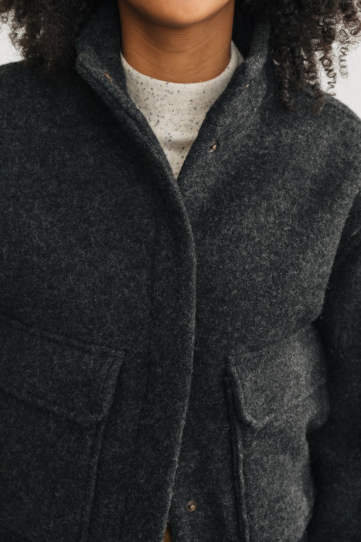 detail of the jacket’s snap button closure and soft texture.