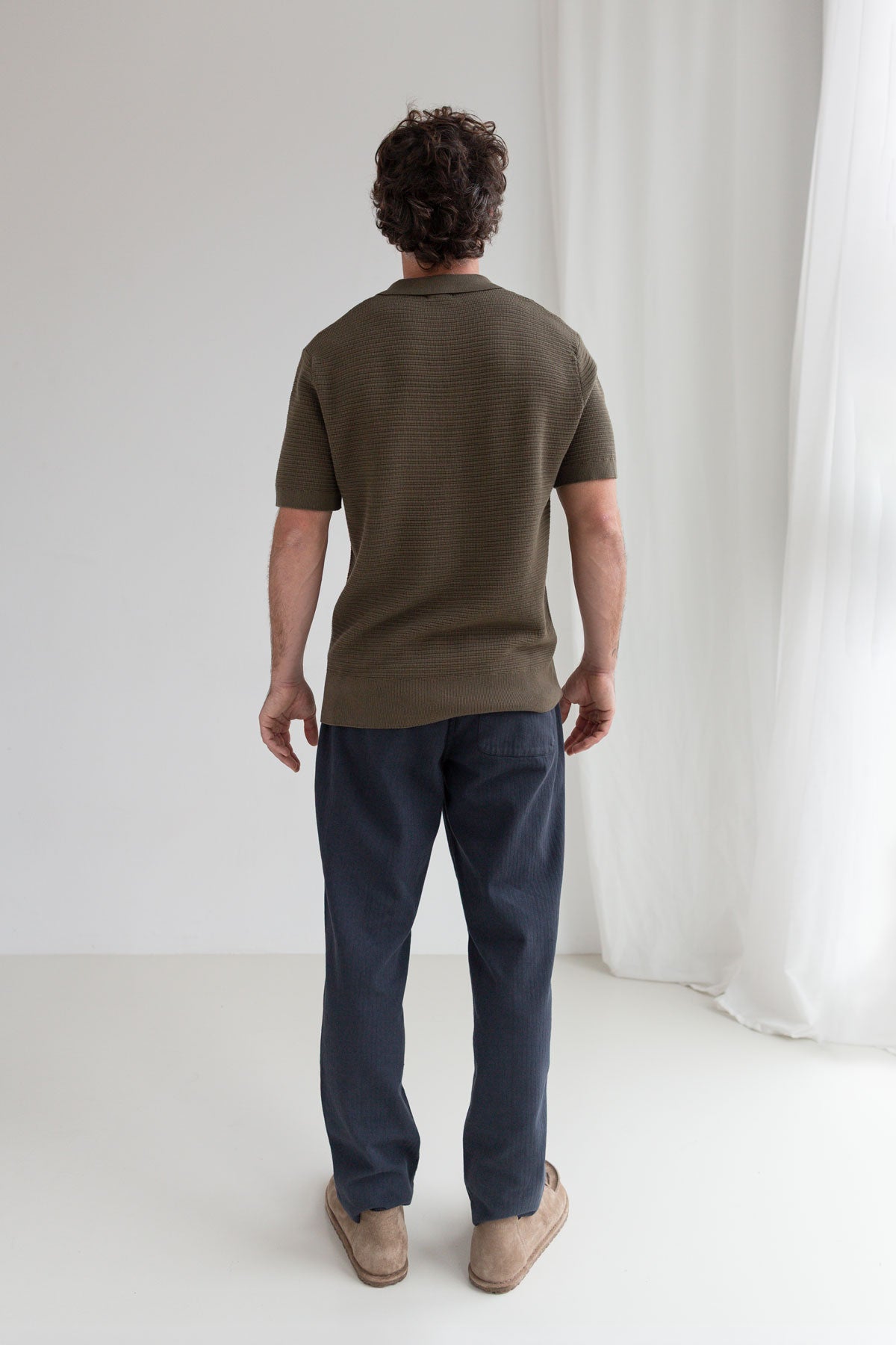 Khaki knit polo shirt men navy pants full body view back