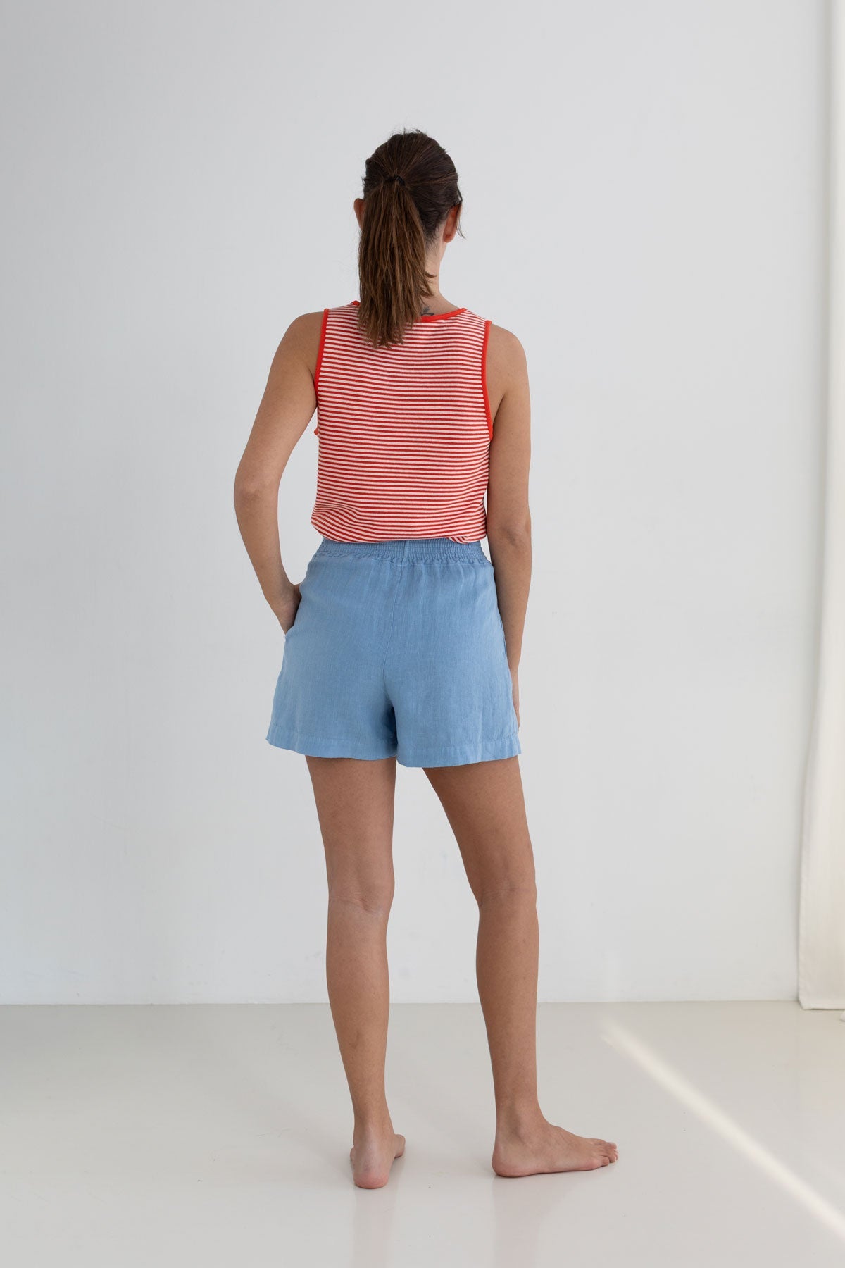 Bright red stripes lightweight vest top women light blue shorts full body view back