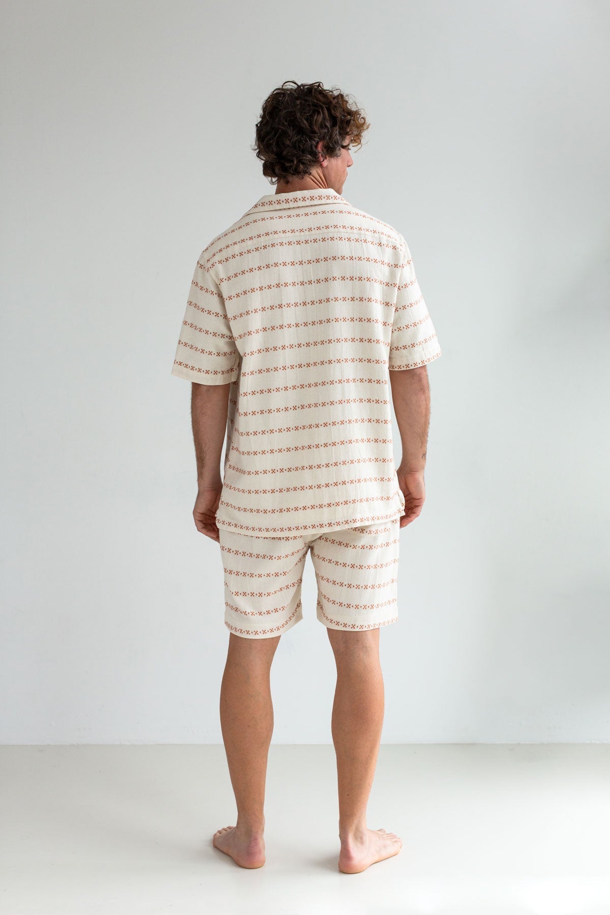 Ecru shorts men patterned shirt full body view back