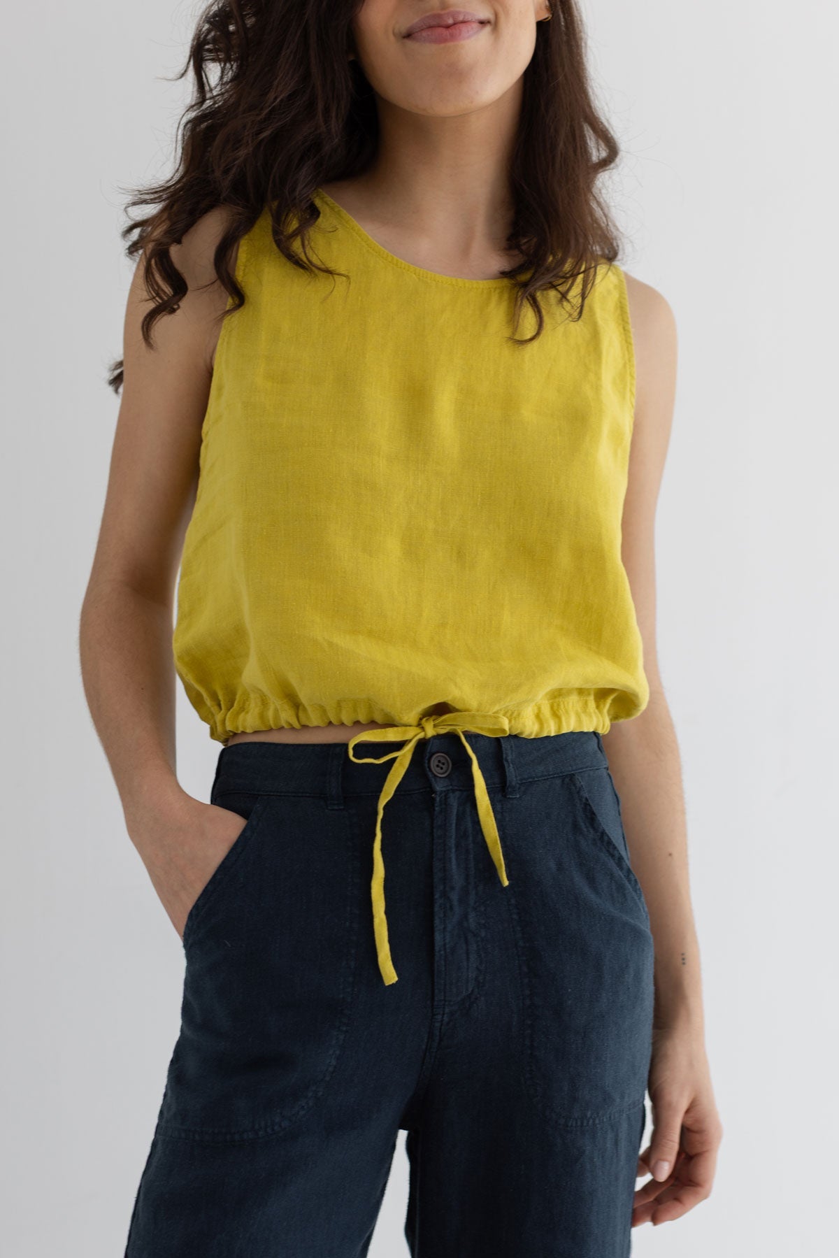 Golden green sleeveless linen shirt women navy pants wear view front