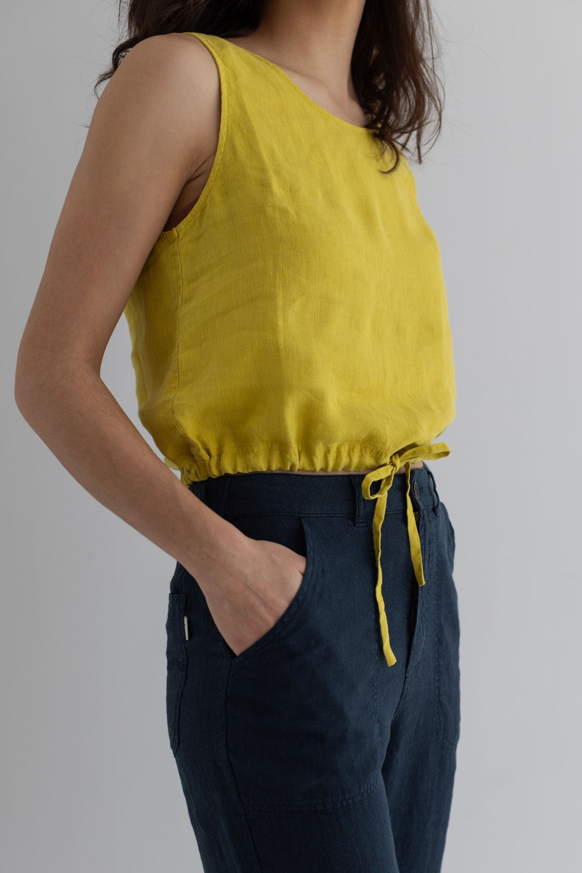Golden green sleeveless linen shirt women navy pants wear view side