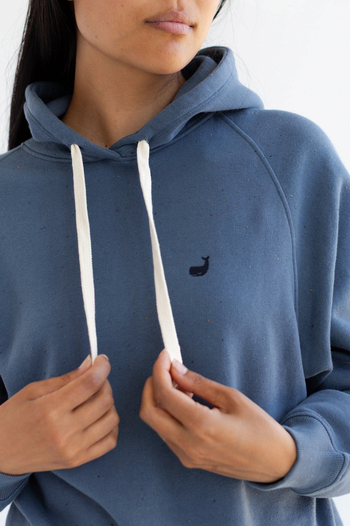 Close-up front view showing the cream drawstrings on a dusty blue hoodie.