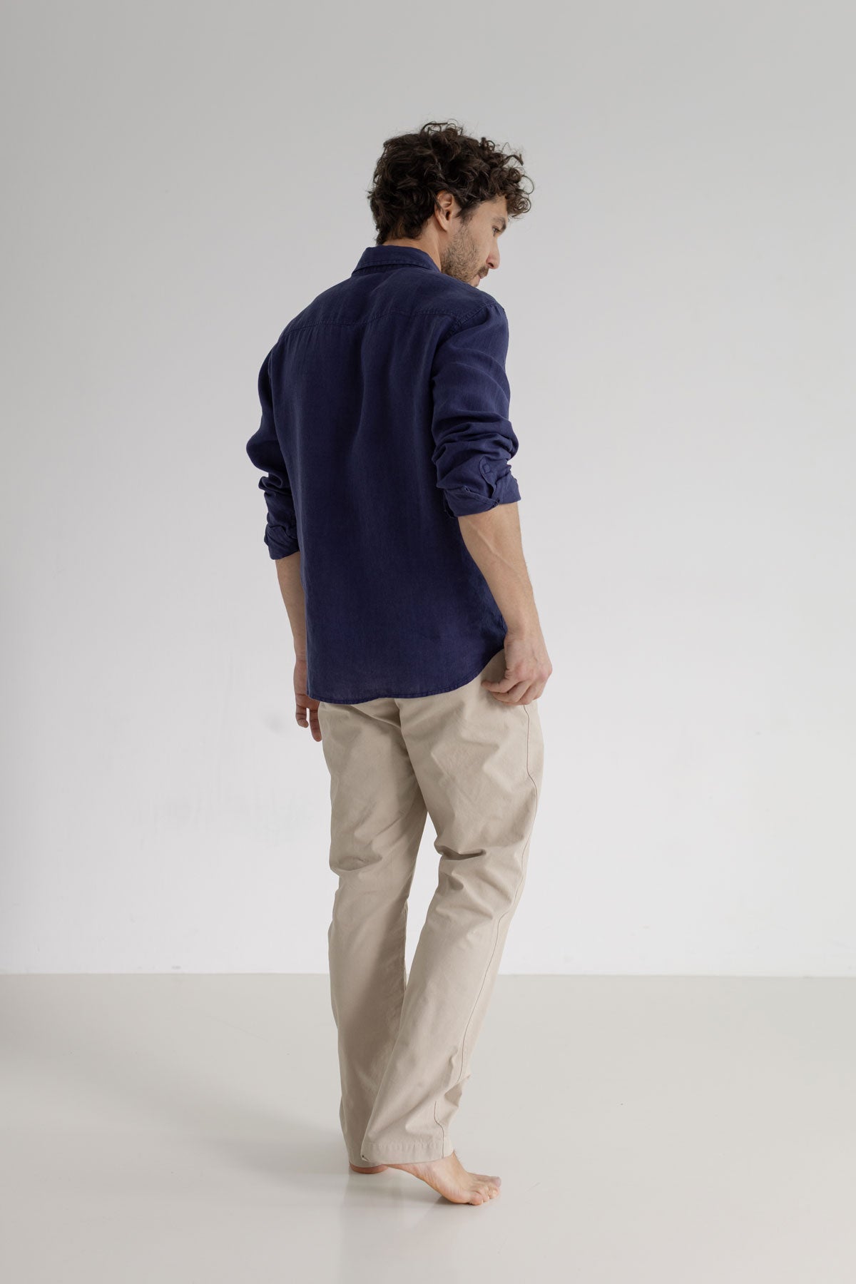 Navy blue linen shirt men light pants full body view back
