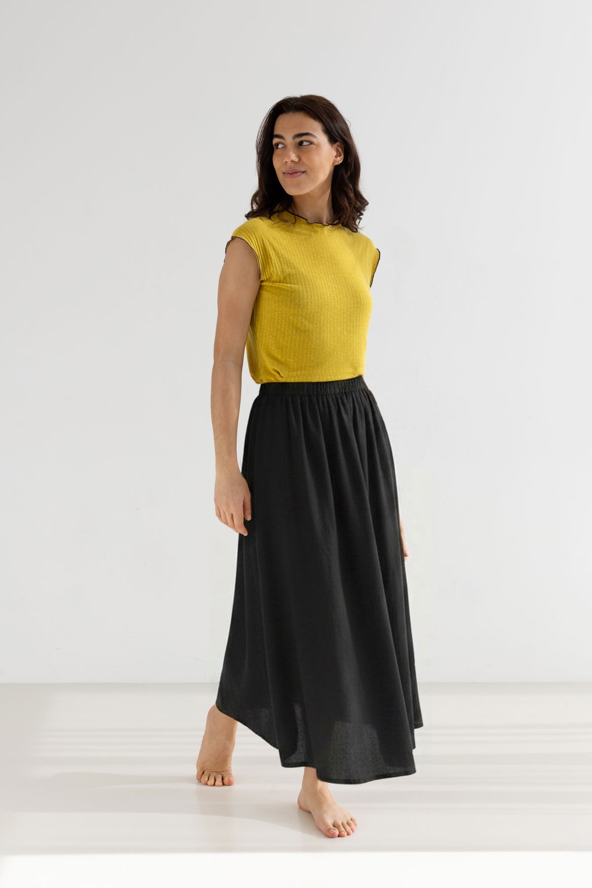 Black linen skirt women yellow top full body view front