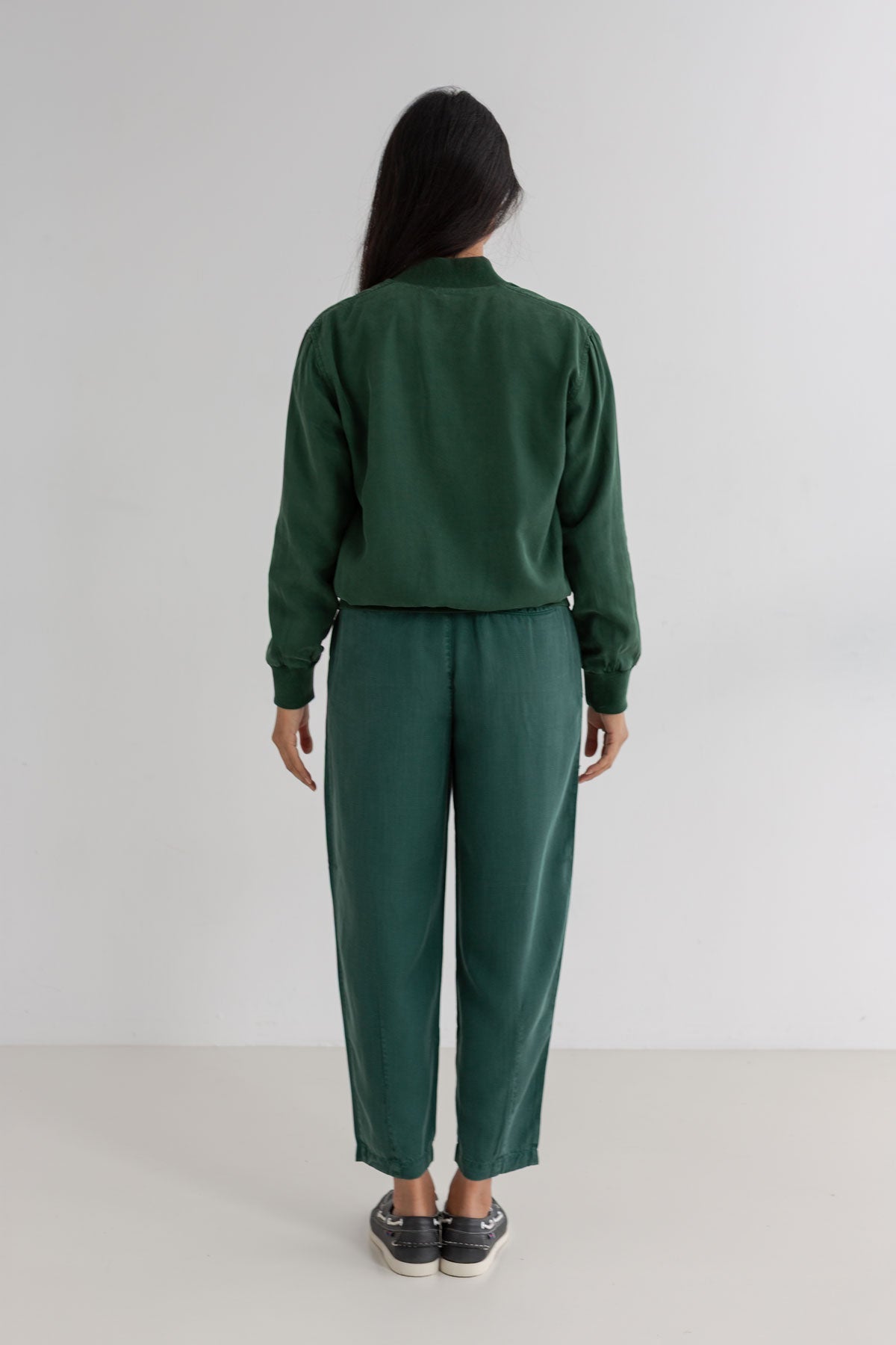 Dark green bomber jacket women green pants full body view back
