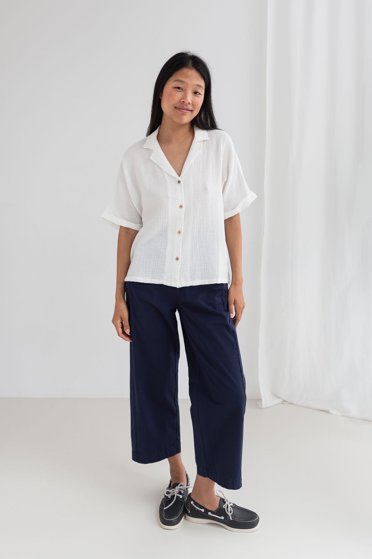 Off white muslin shirt women navy pants full body view front