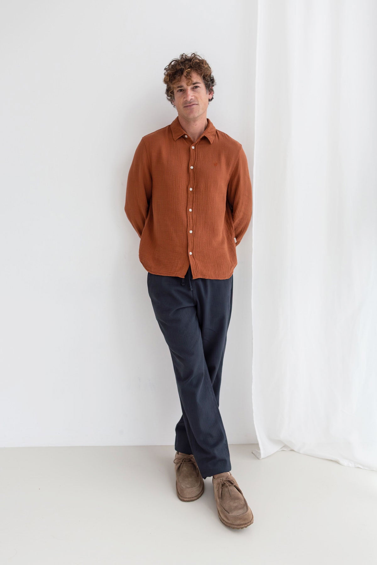 Reddish brown muslin shirt men navy pants full body view front