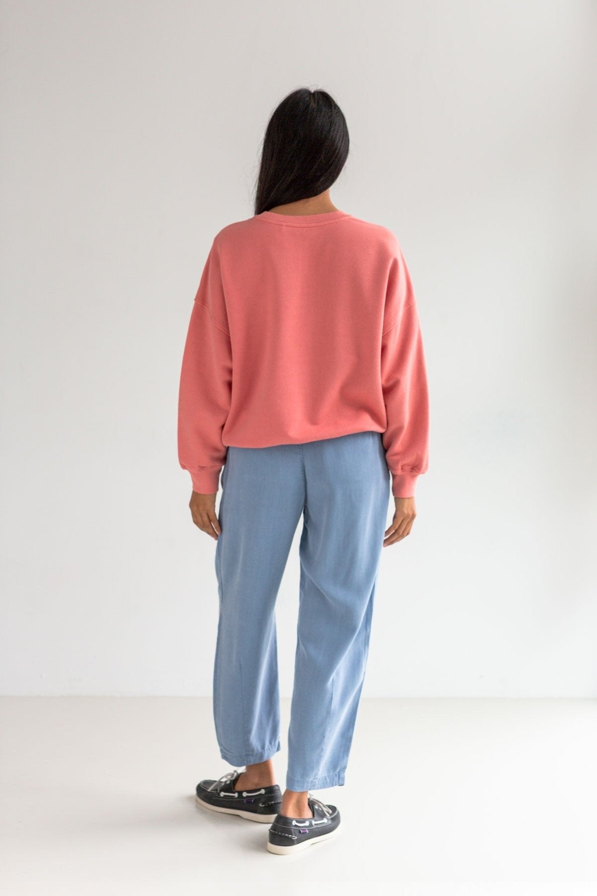 Pink American fleece sweatshirt women  light blue pants full body view back