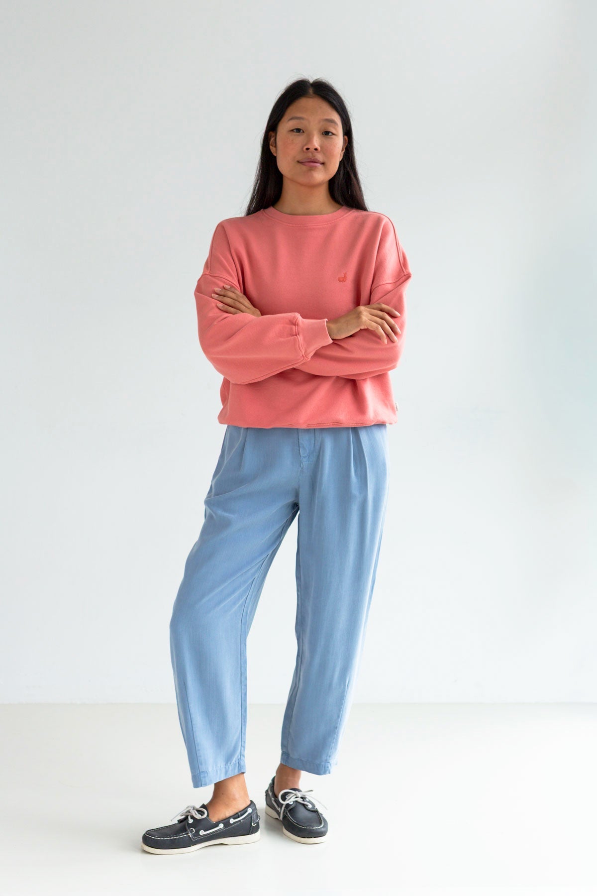 Pink American fleece sweatshirt women light blue pants full body view front 
