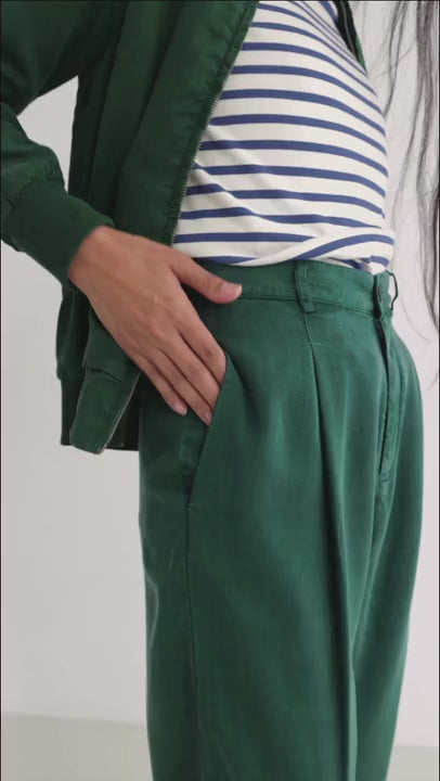Dark green lyocell pants women striped tshirt green jacket full body view 